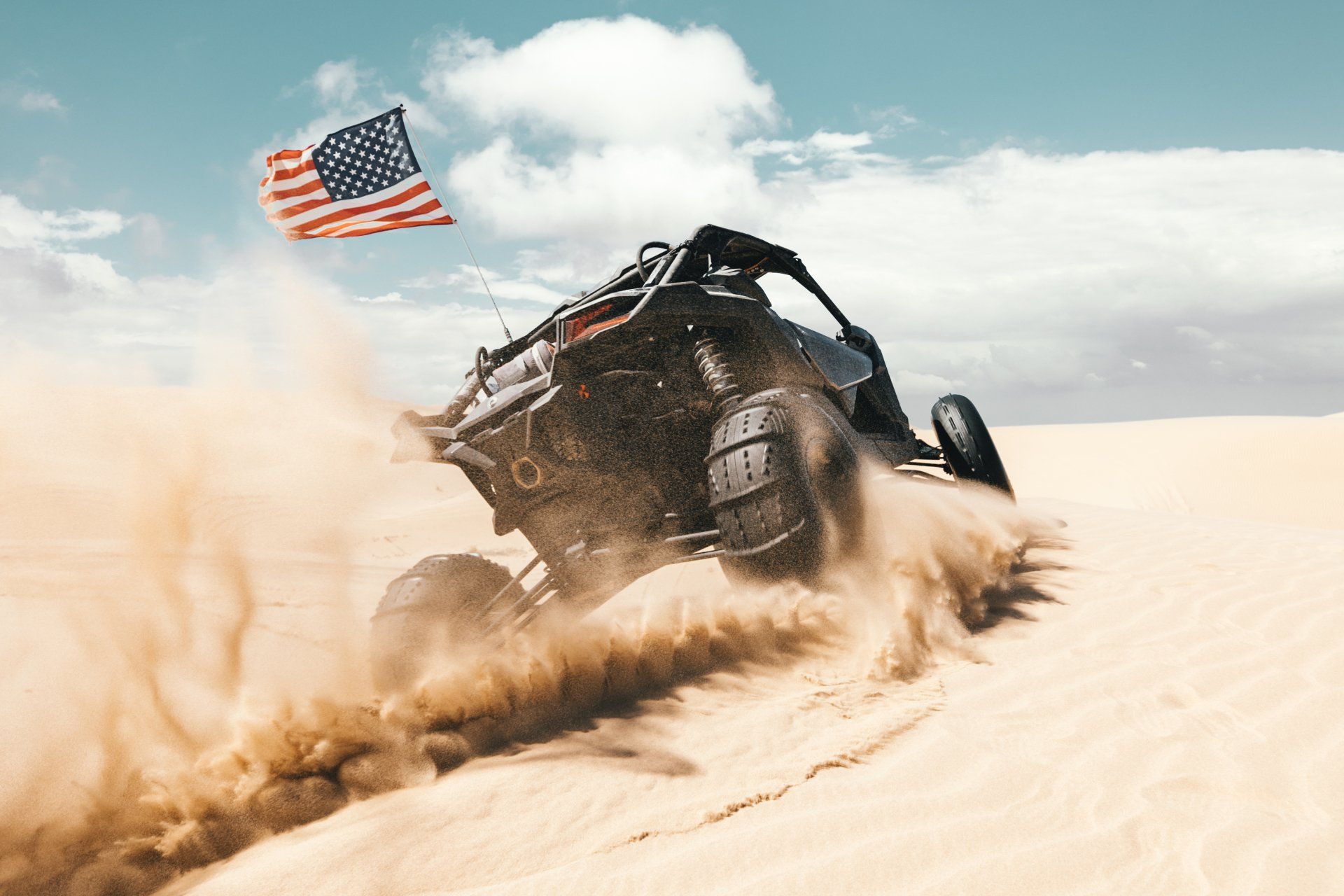 atv driving through sand