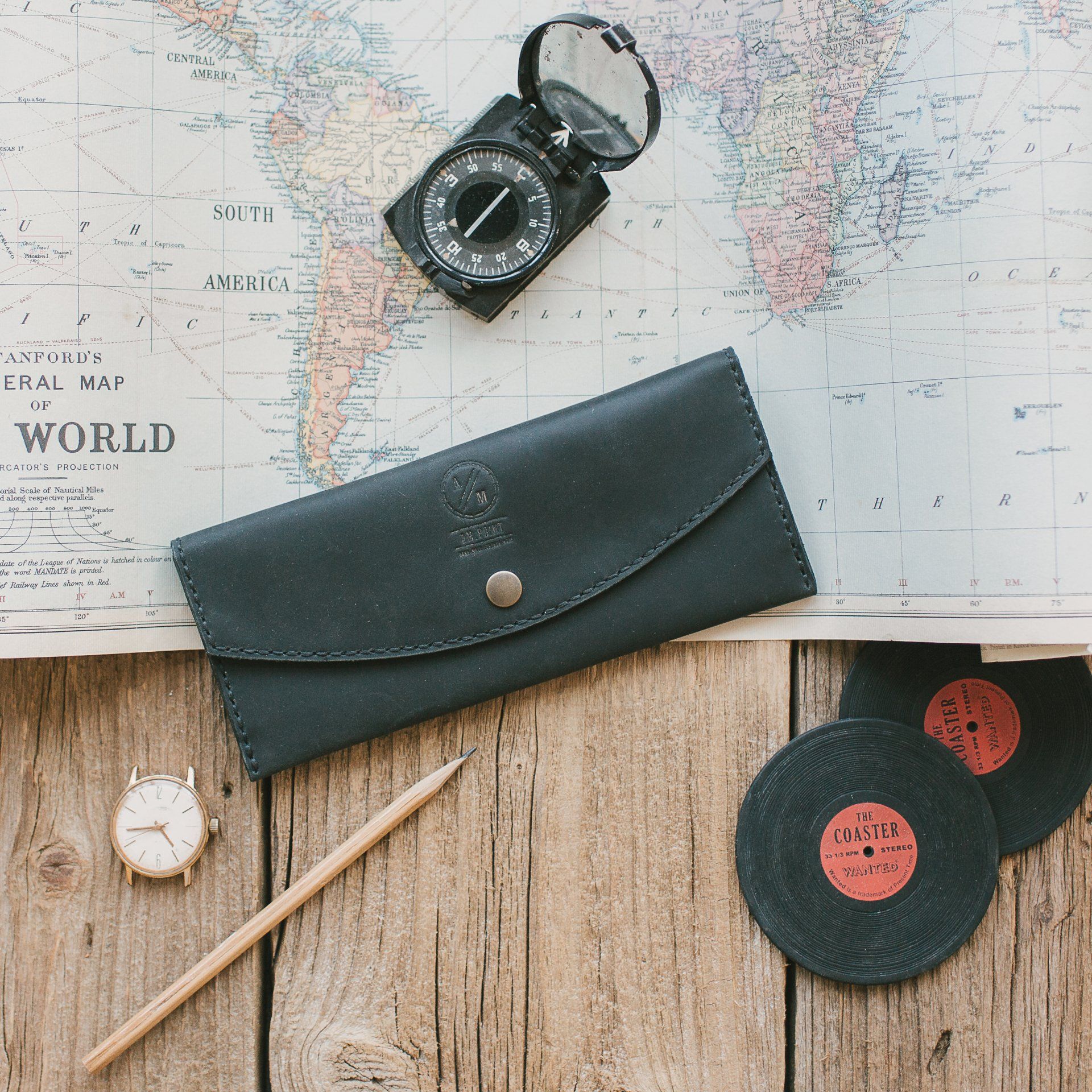 A map of the world is on a wooden table