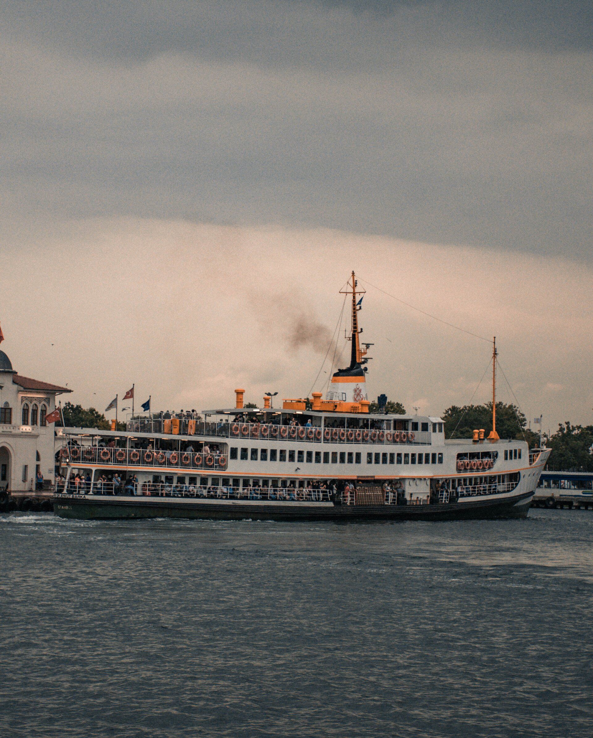 A large cruise ship is floating on top of a body of water