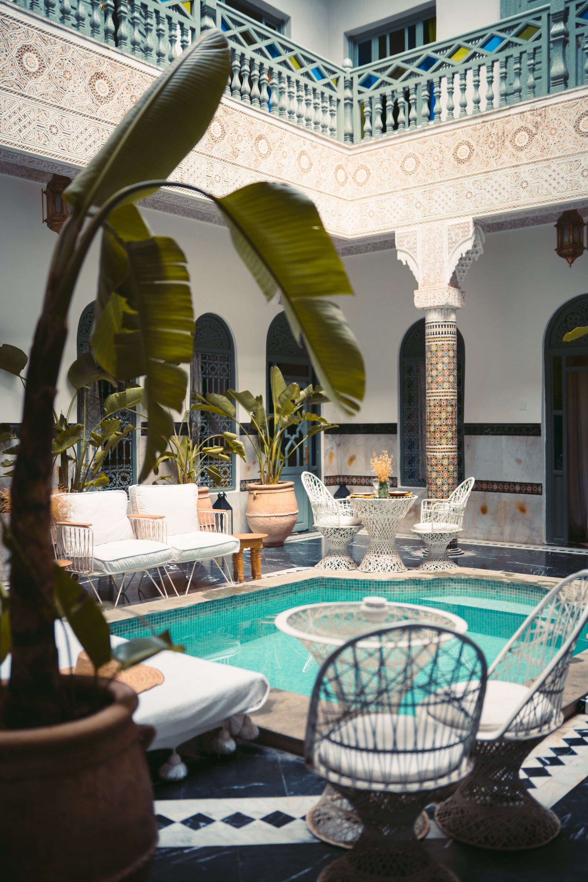 There is a swimming pool in the middle of the courtyard of a building.