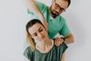 male provider stretching a woman's neck