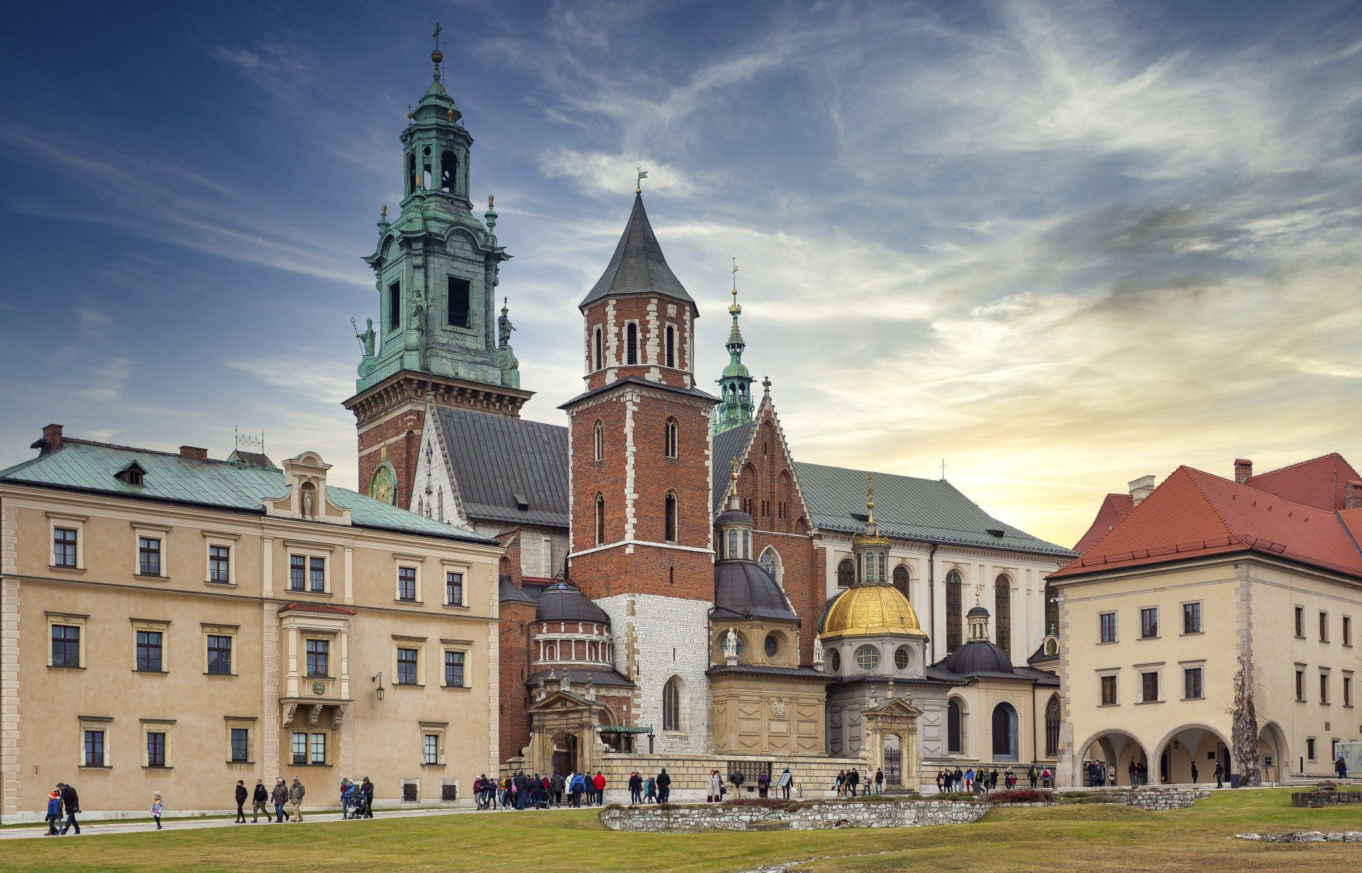 A large building with a clock tower in the middle of a city.