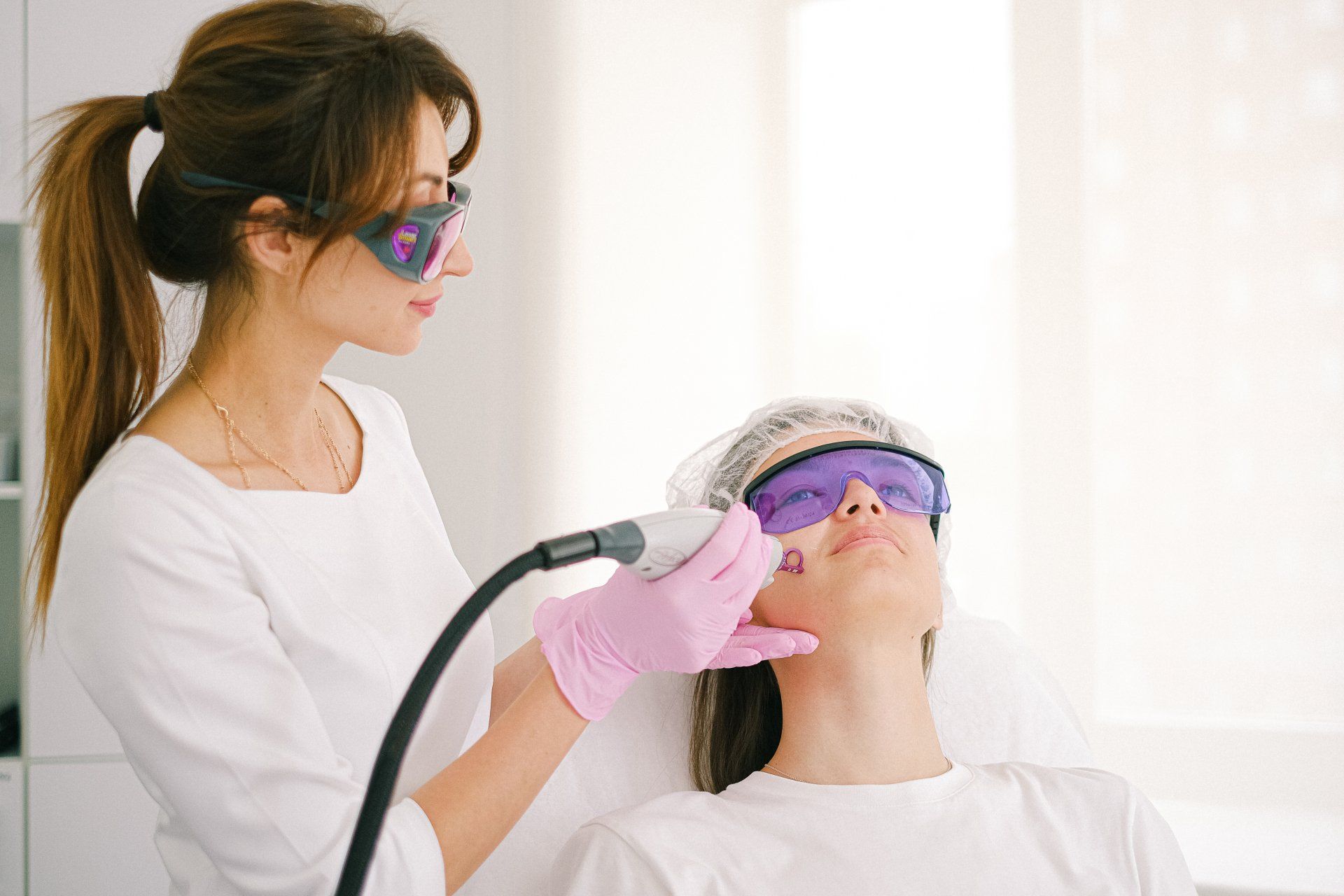 Laser operator applying laser treatment to patient's jaw