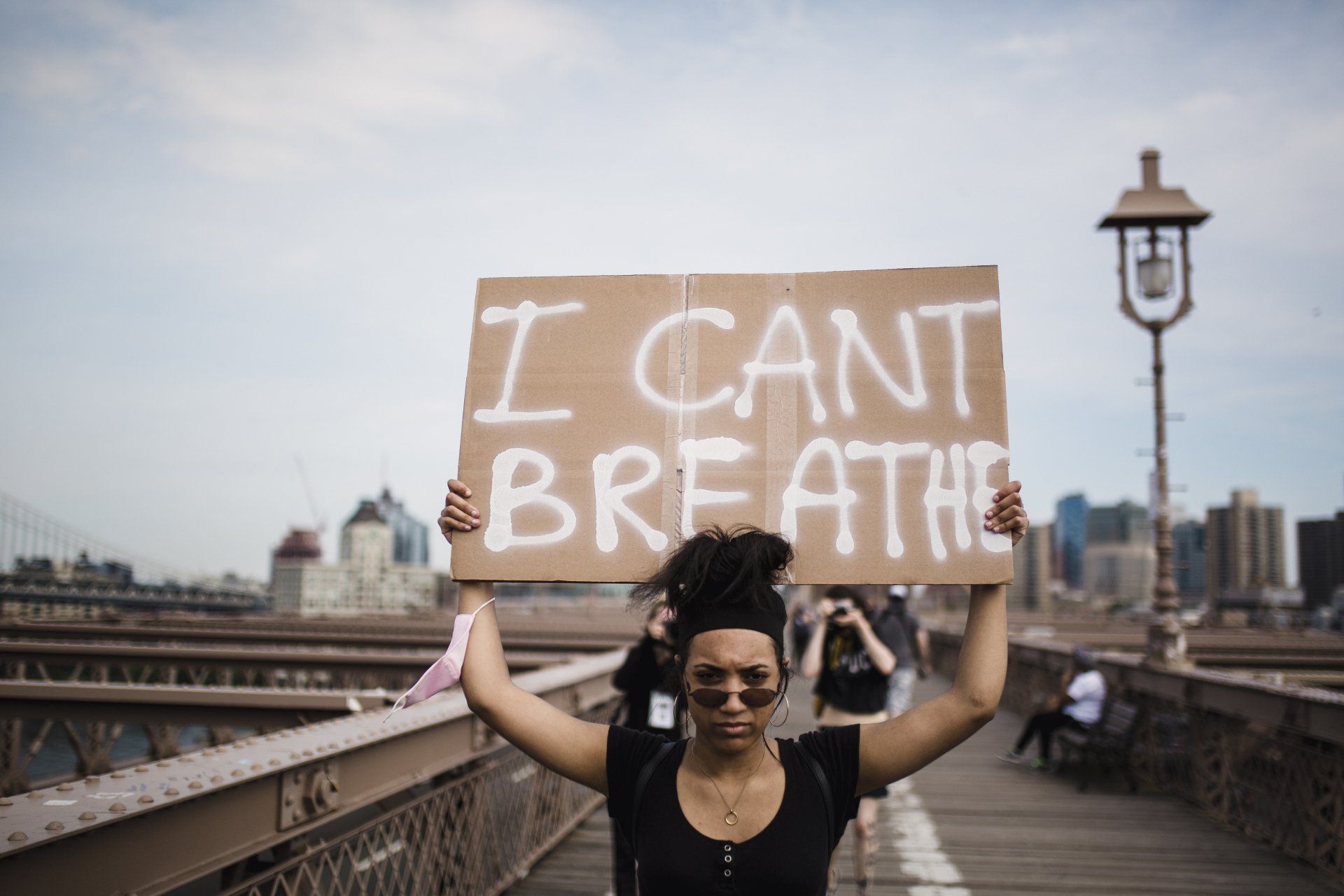woman holding sign reading