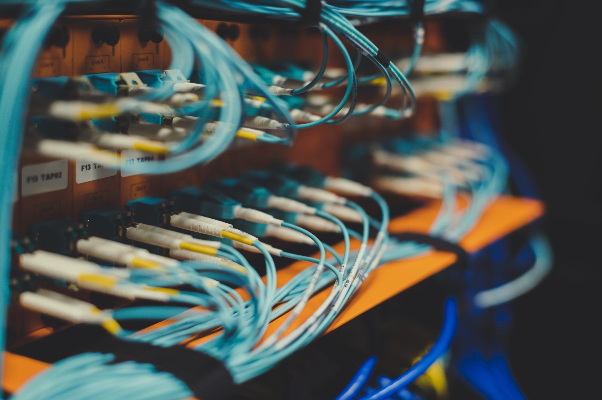 A bunch of wires are connected to each other in a server room.