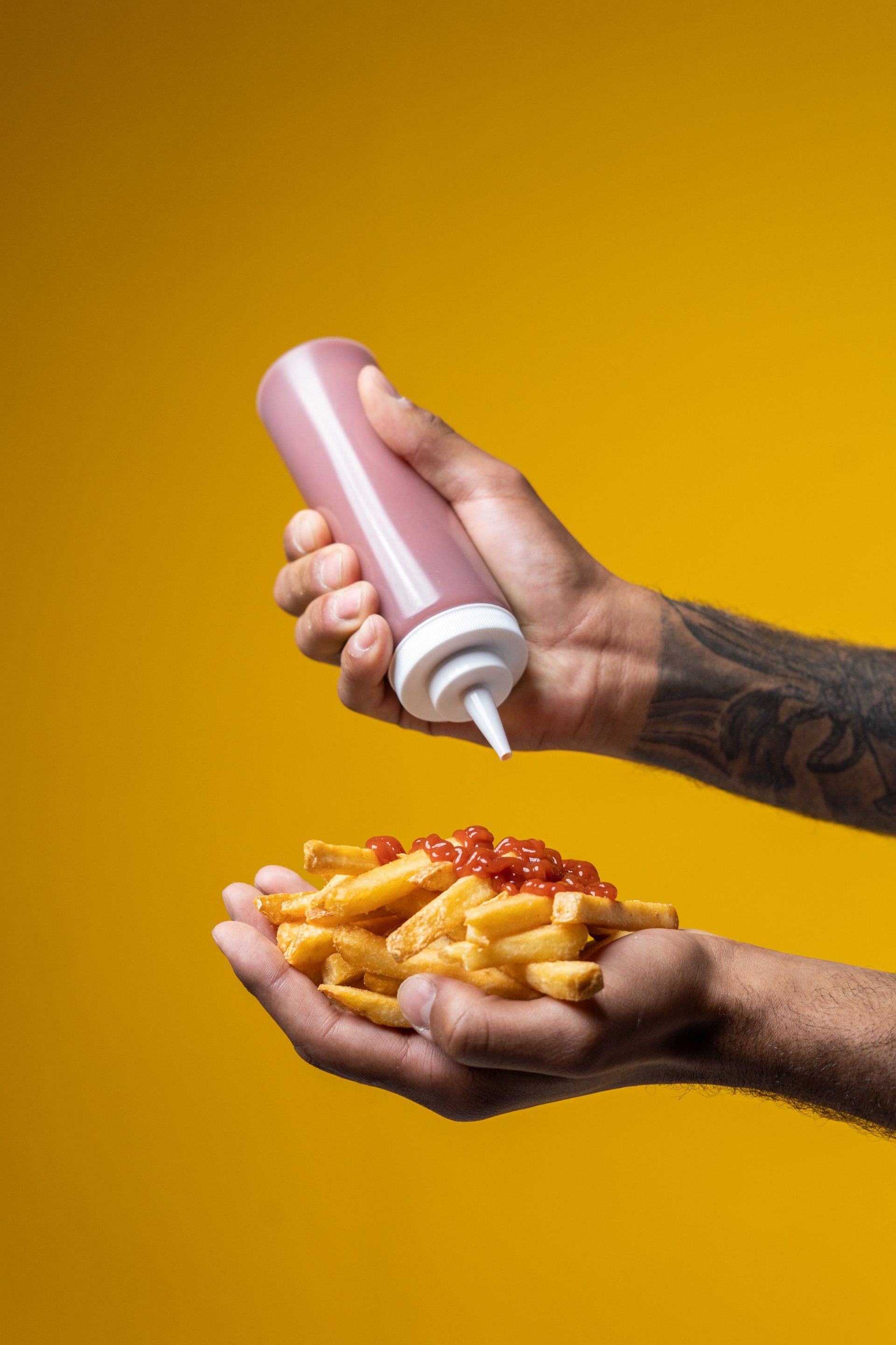 A person is pouring ketchup on french fries | Rent a french fry machine in New Jersey