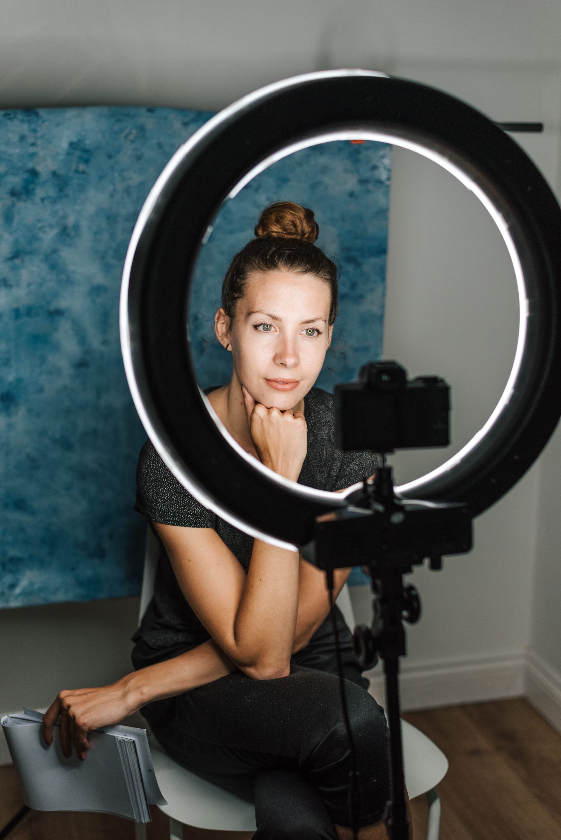Woman taking selfie with ring light