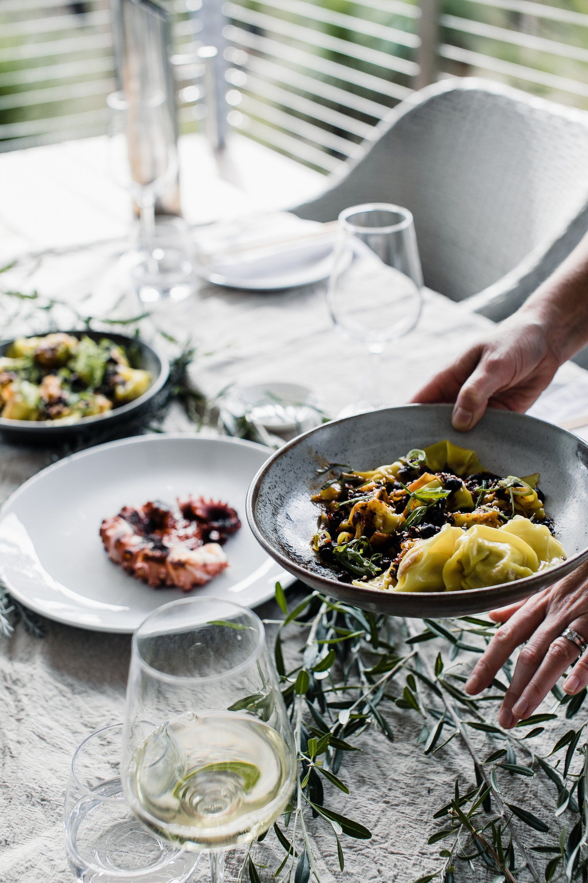 Une personne tient une assiette de nourriture sur une table.