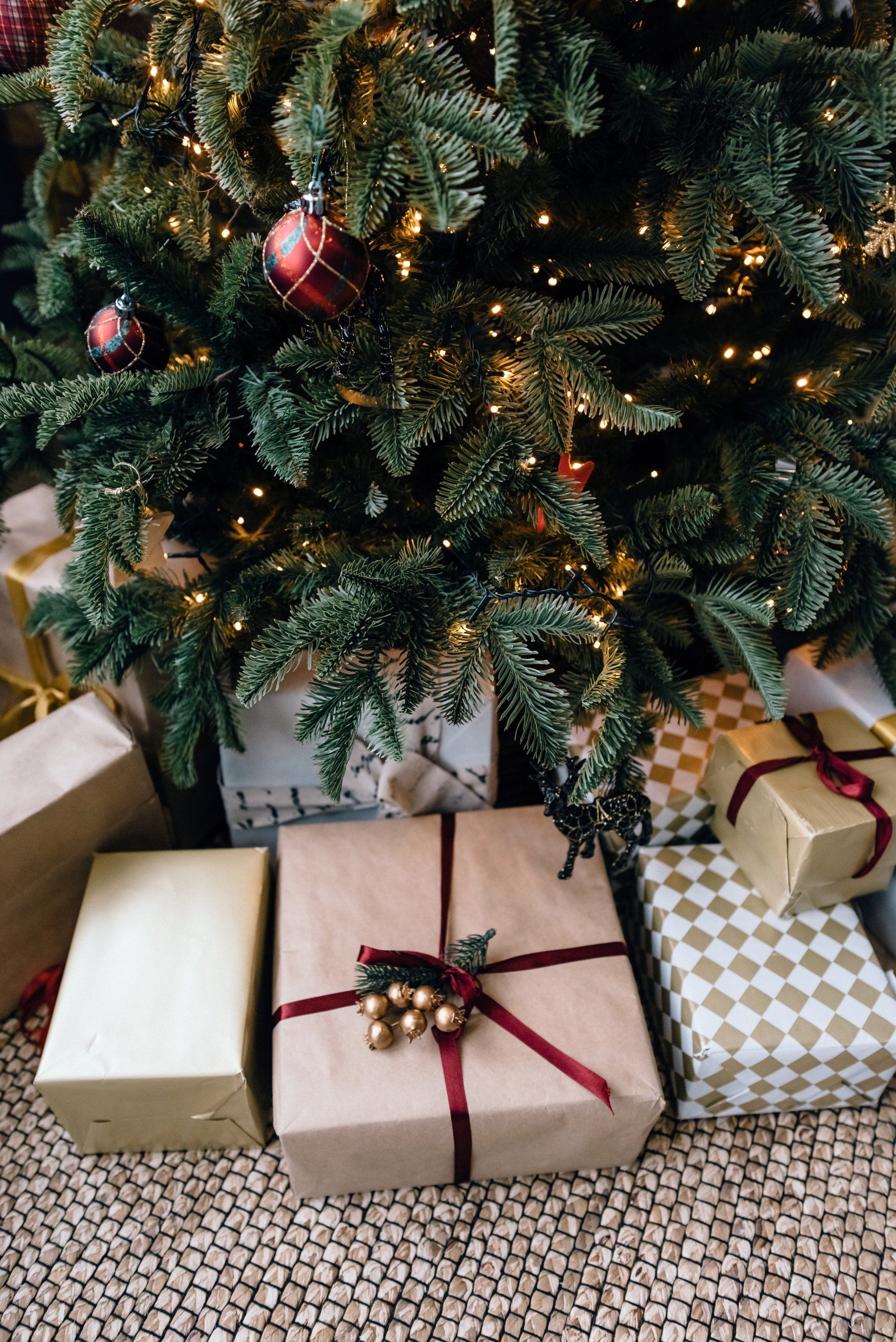 A christmas tree with lots of presents underneath it