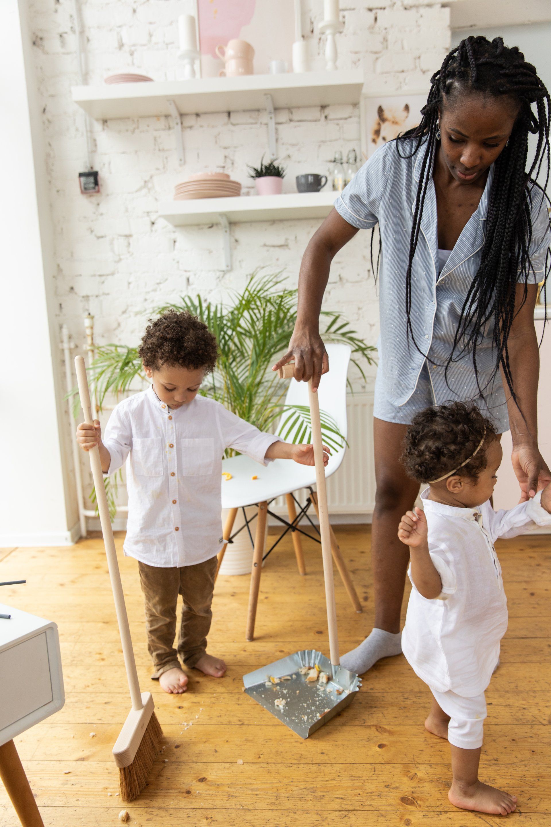 a child helping with sweeping the floor