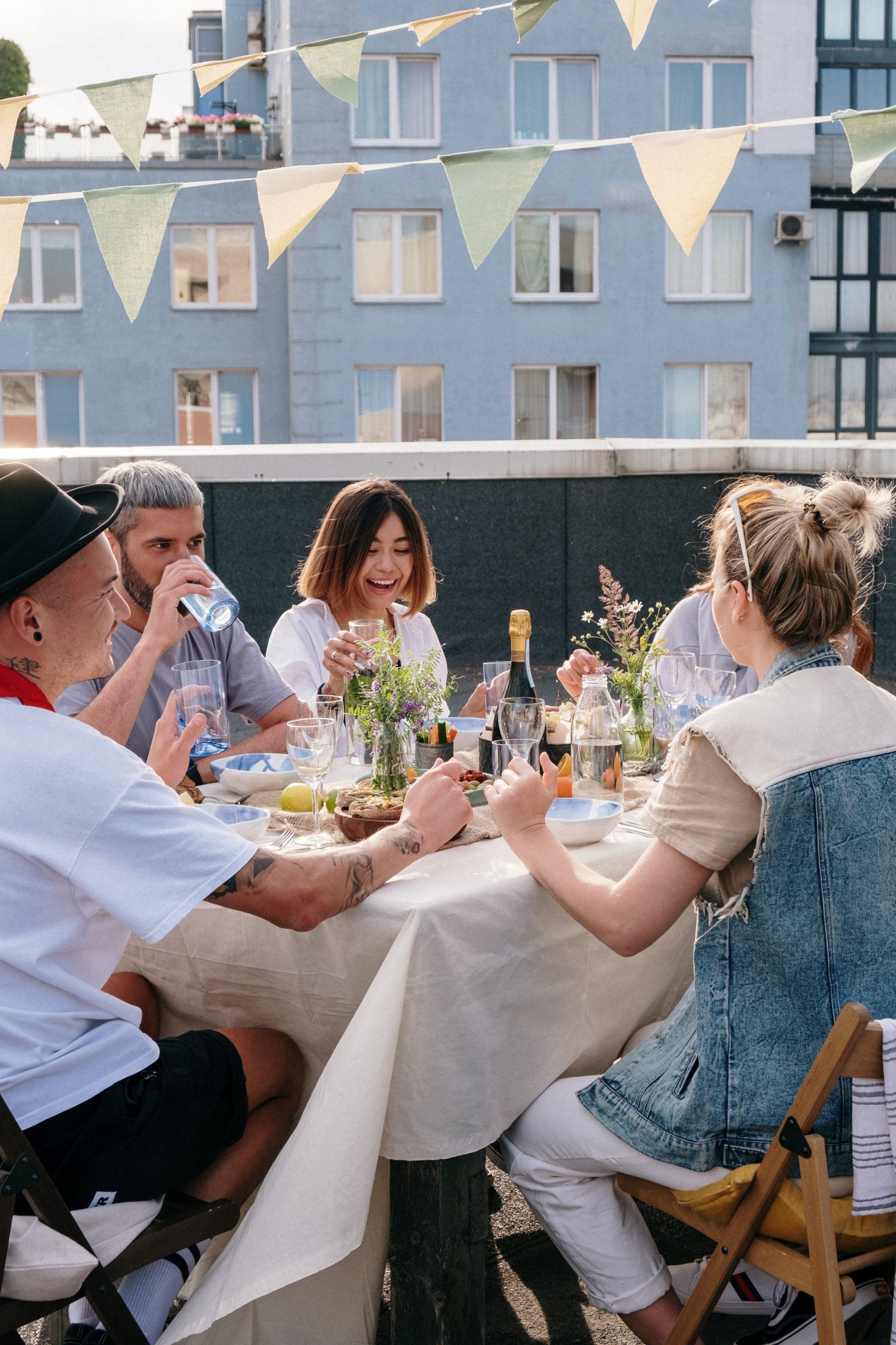 A group of people are sitting around a table eating food.