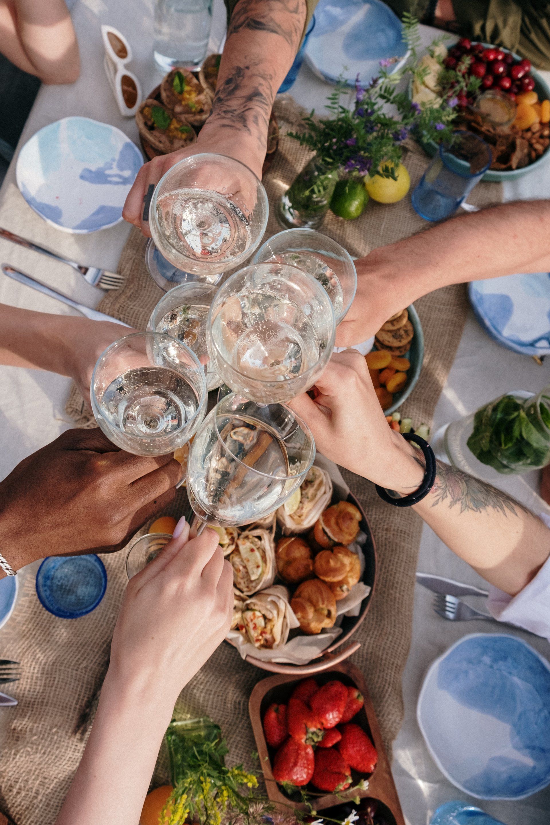 A group of people are toasting with glasses of drink