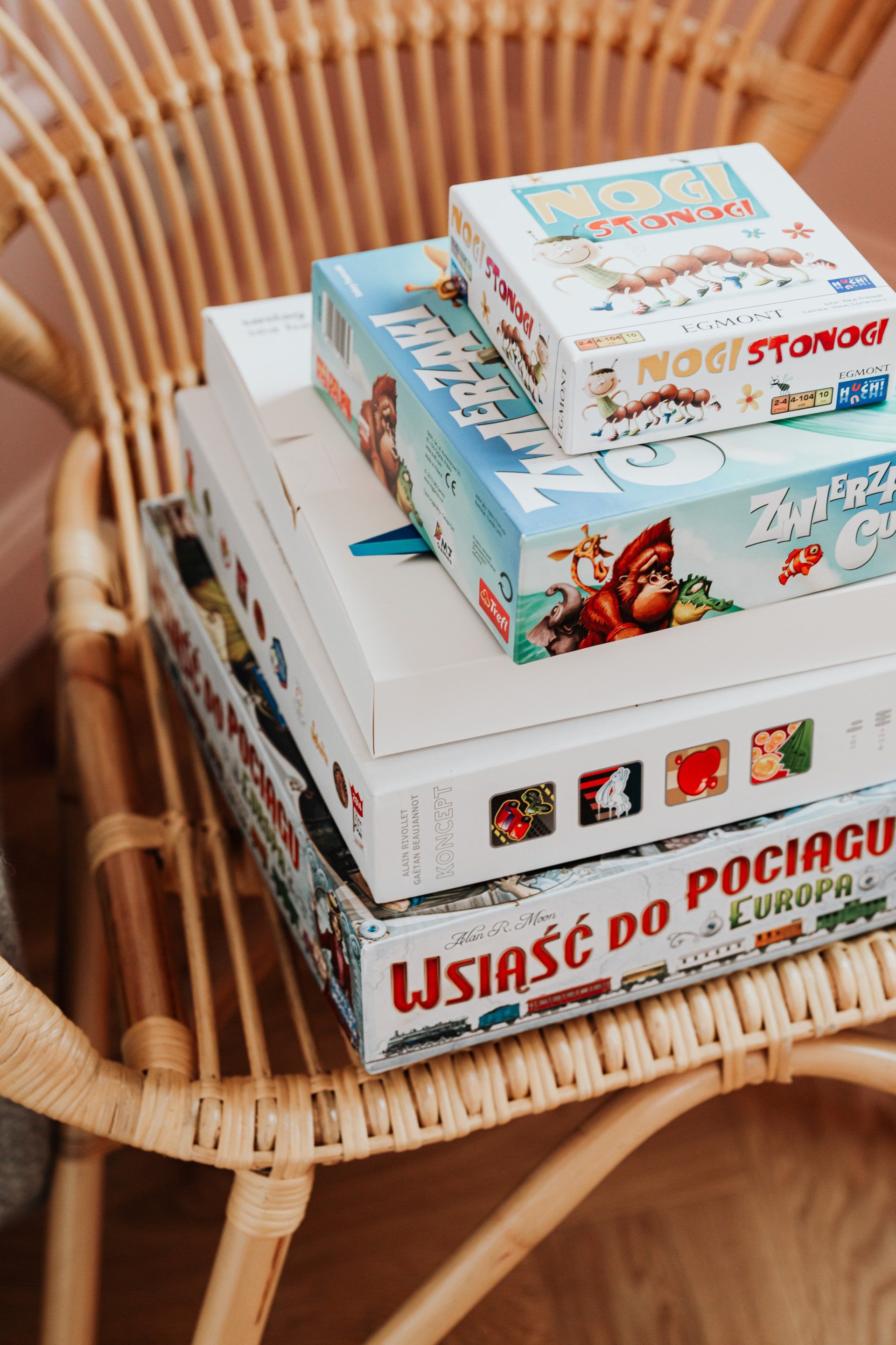 A stack of boxes sitting on top of each other on a wicker chair.