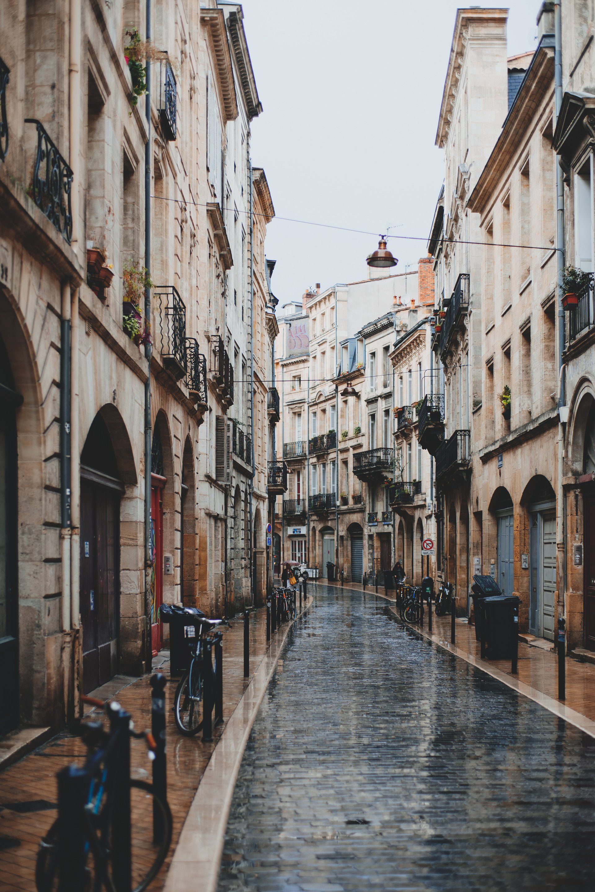 A narrow cobblestone street lined with building storefronts symbolic of a business website in marketing.