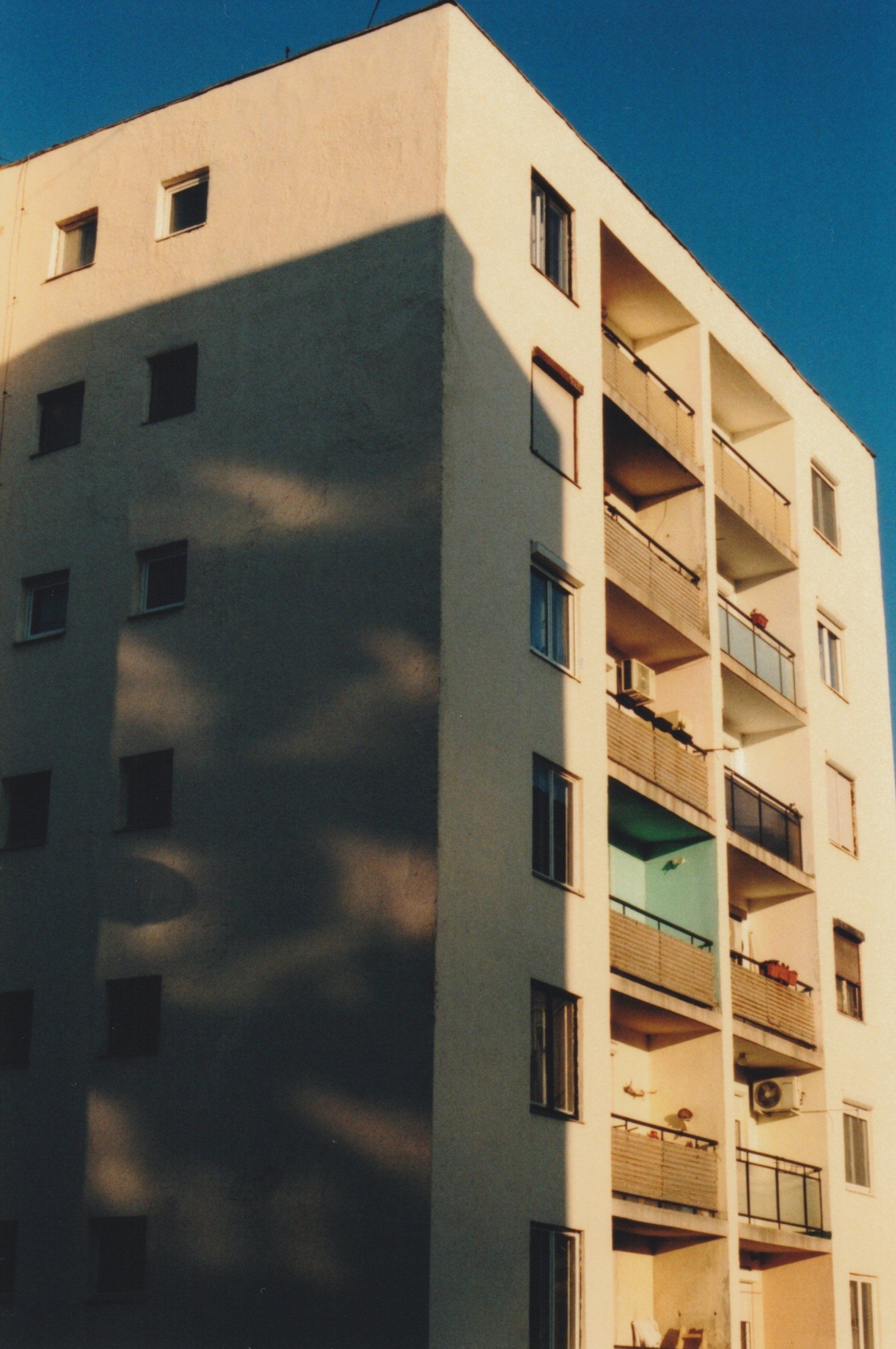 a tall building with a lot of windows and balconies