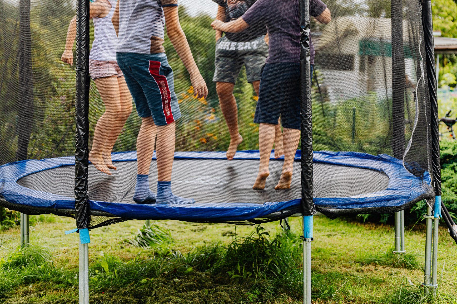 A group of people are jumping on a trampoline.