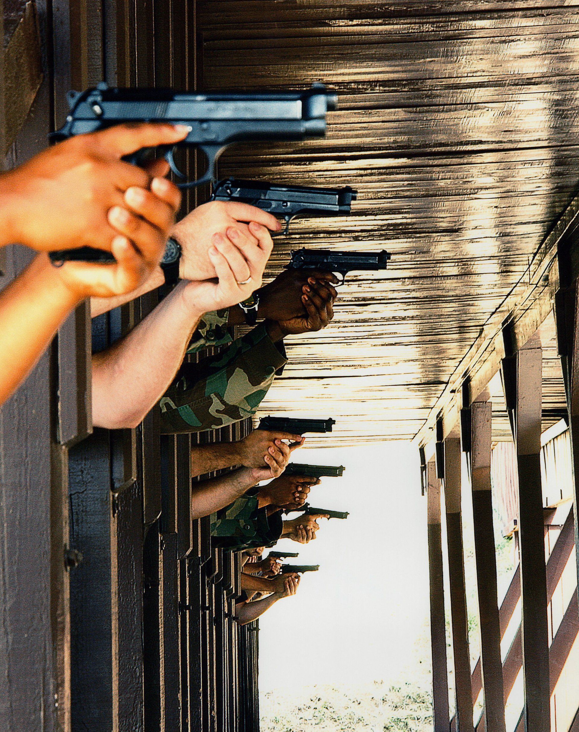 a picture of hands holding guns .