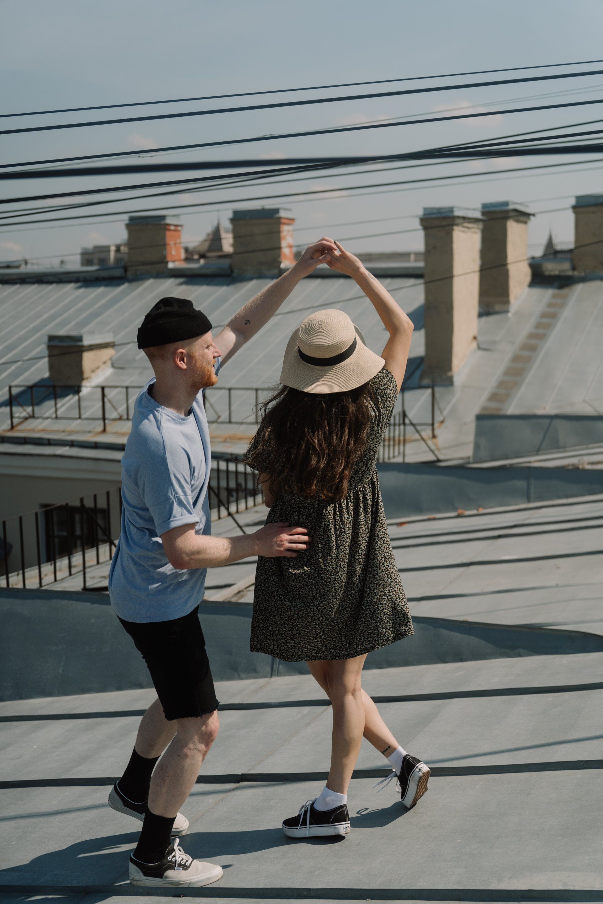 A man and a woman are dancing on the roof of a building.