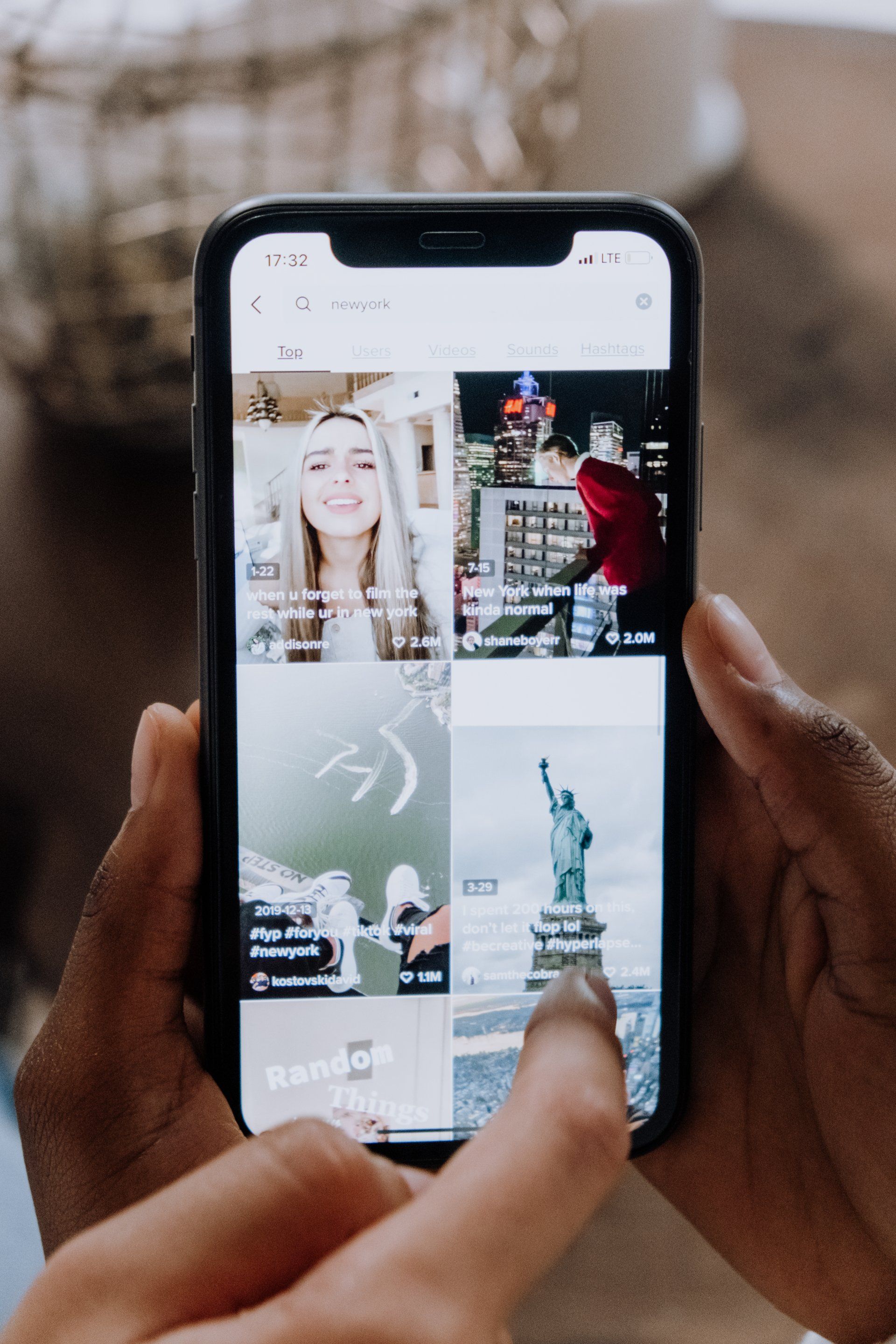 A person is holding a cell phone in their hands.