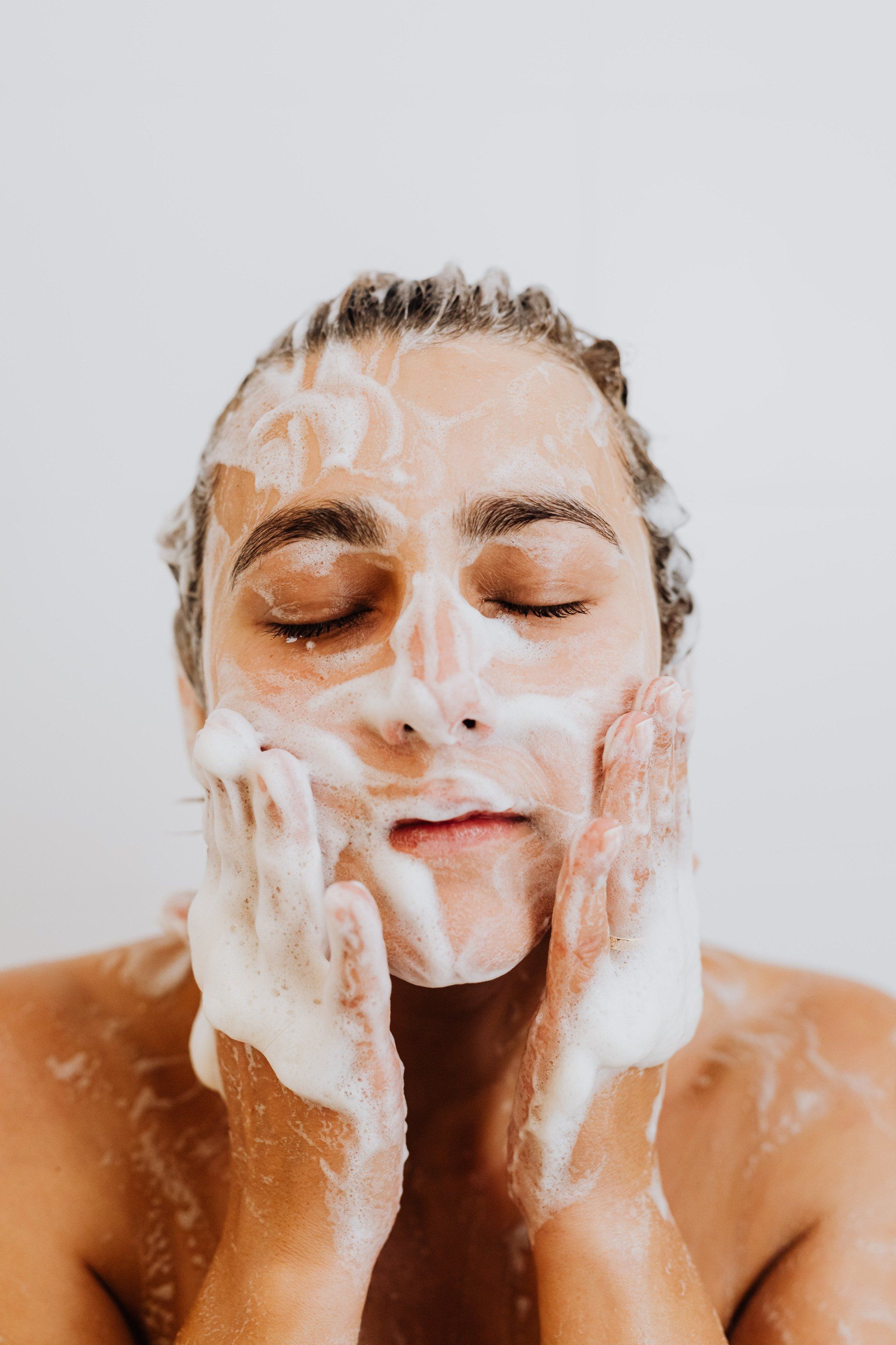 a woman washing her face