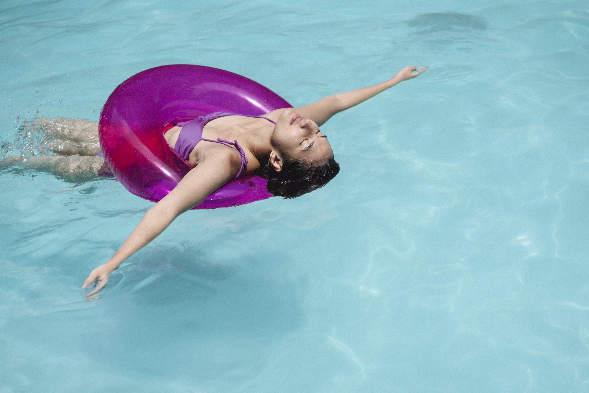 Woman floating on tube in pool