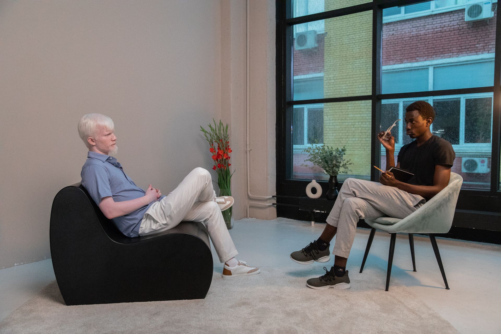 2 men casually sitting doing an interview