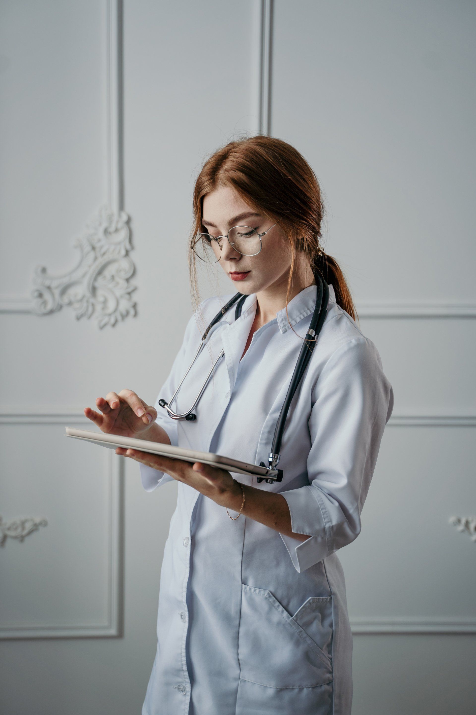 Doctor looking at her chart