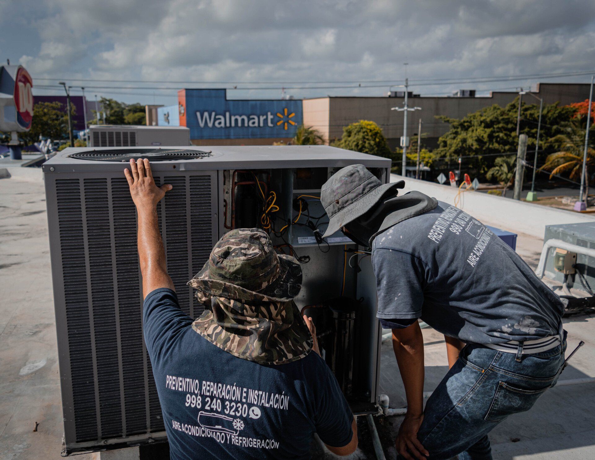 Technicians servicing rooftop mechanical equipment