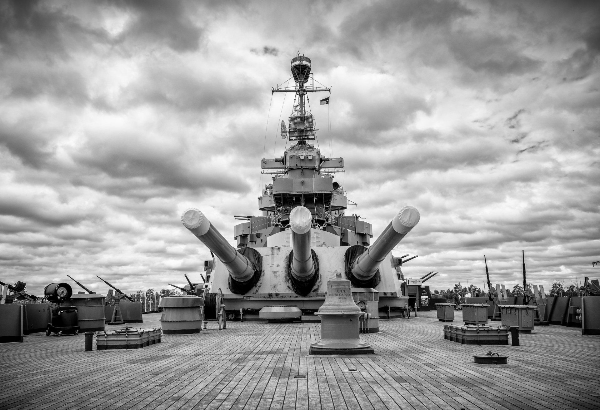 A black and white photo of a large battleship on a cloudy day.