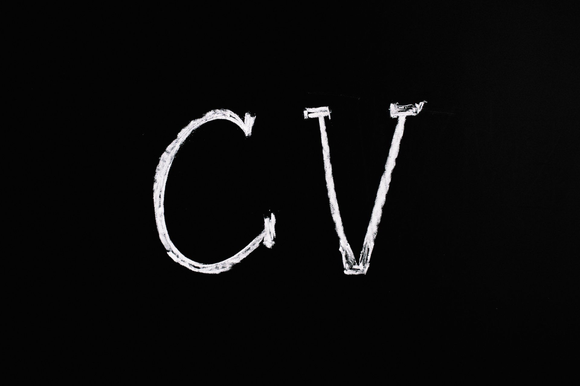The word cv is written in white chalk on a black background.