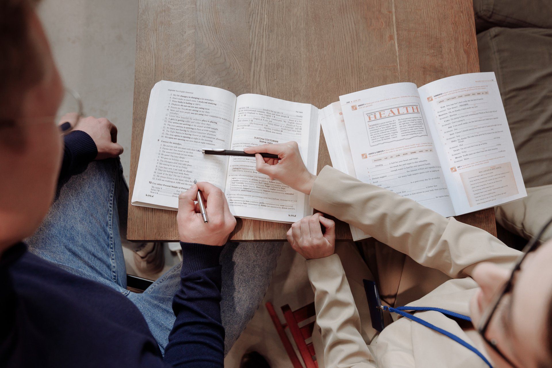 Two people study a book