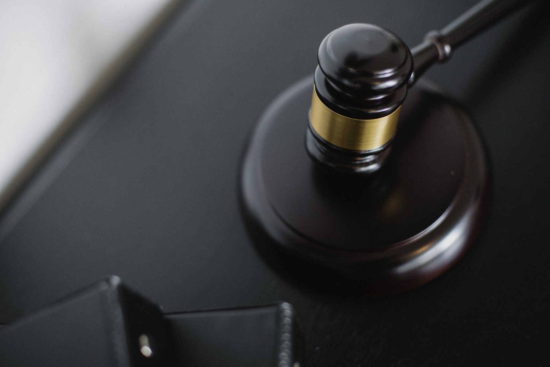 A close up of a judge's gavel on a table.