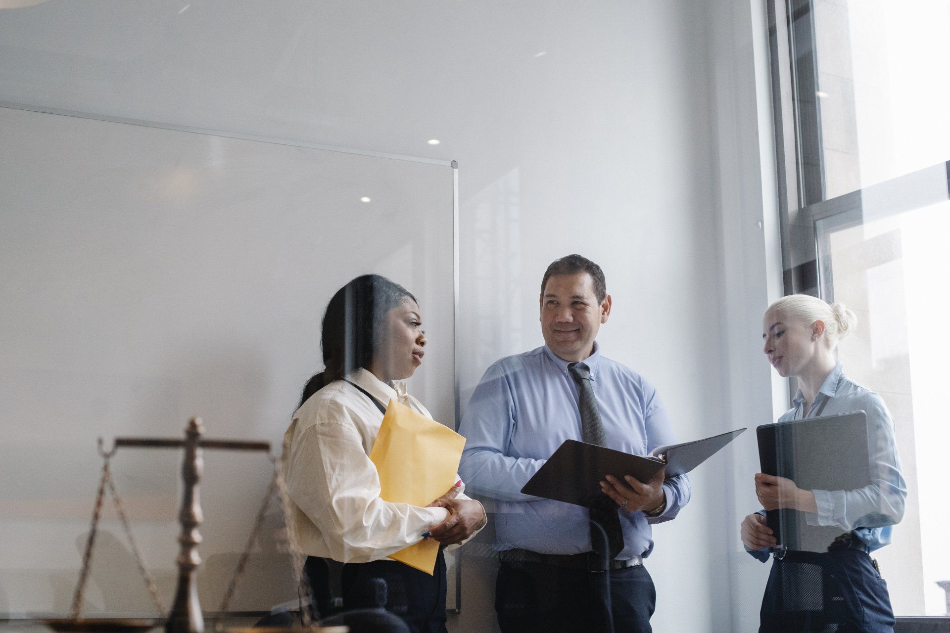A group of people are standing next to each other in a room.
