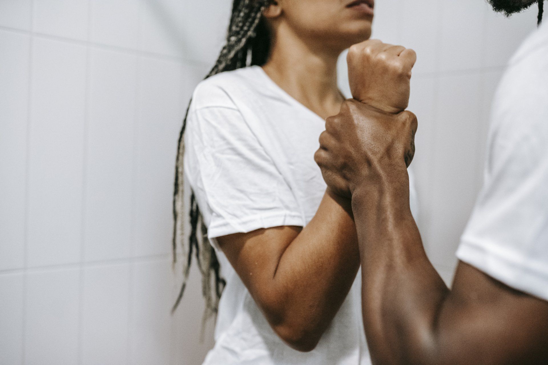 A man is holding a woman 's hand in front of a mirror.