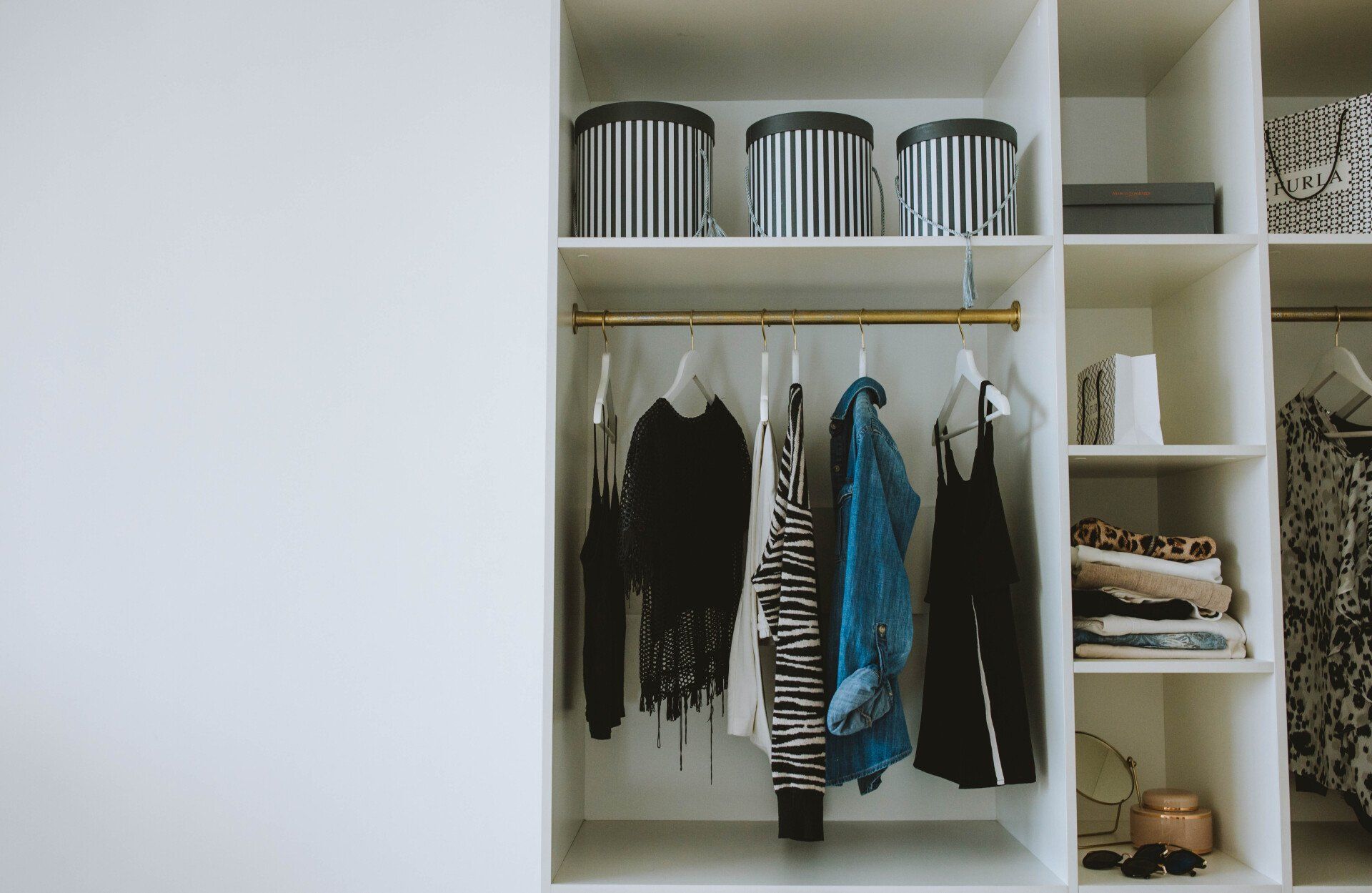 a closet filled with clothes and baskets .