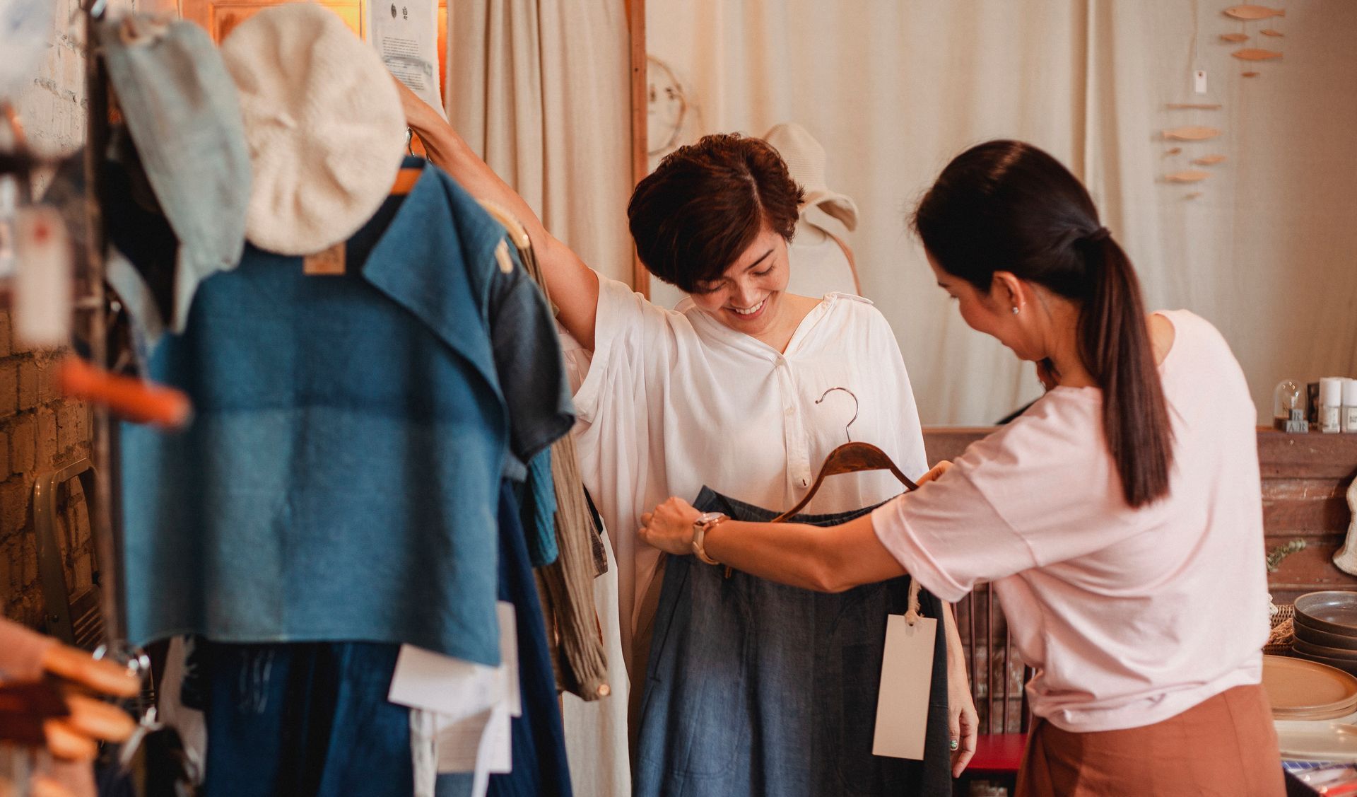 two women looking at clothing.