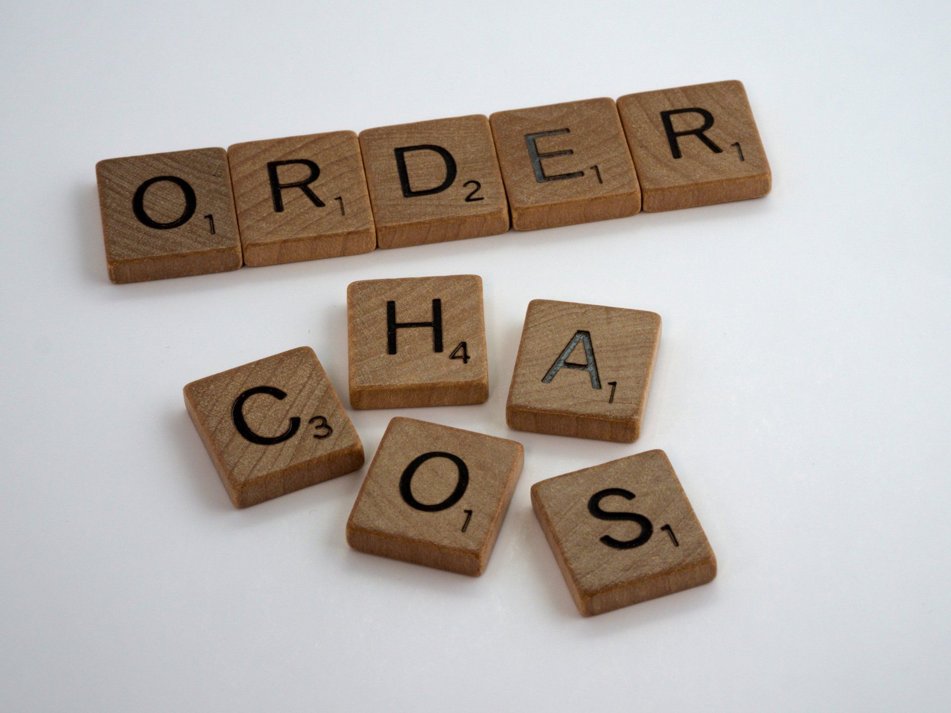 The word order is written in scrabble tiles on a white surface.