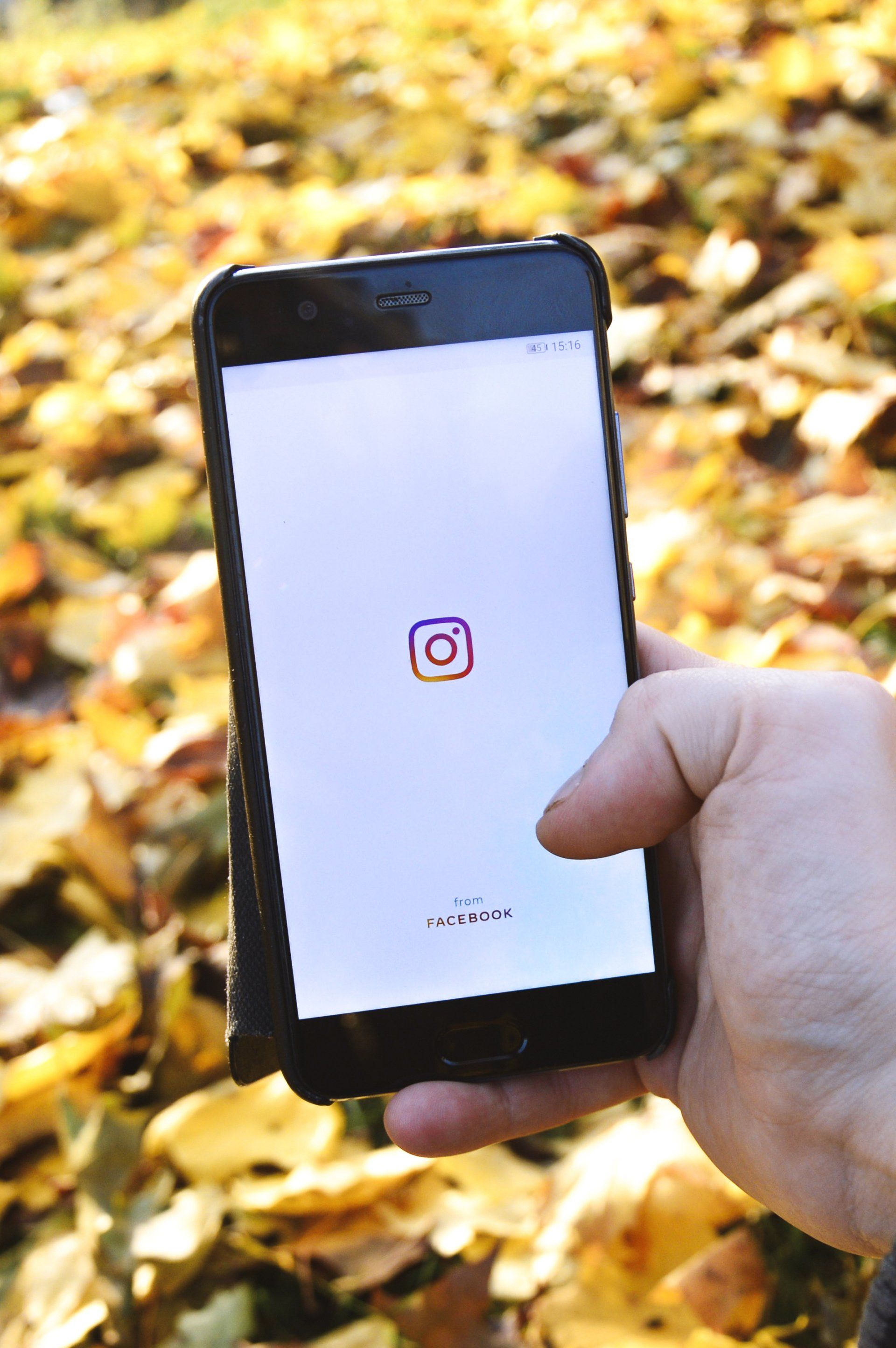hand holding phone with instagram logo