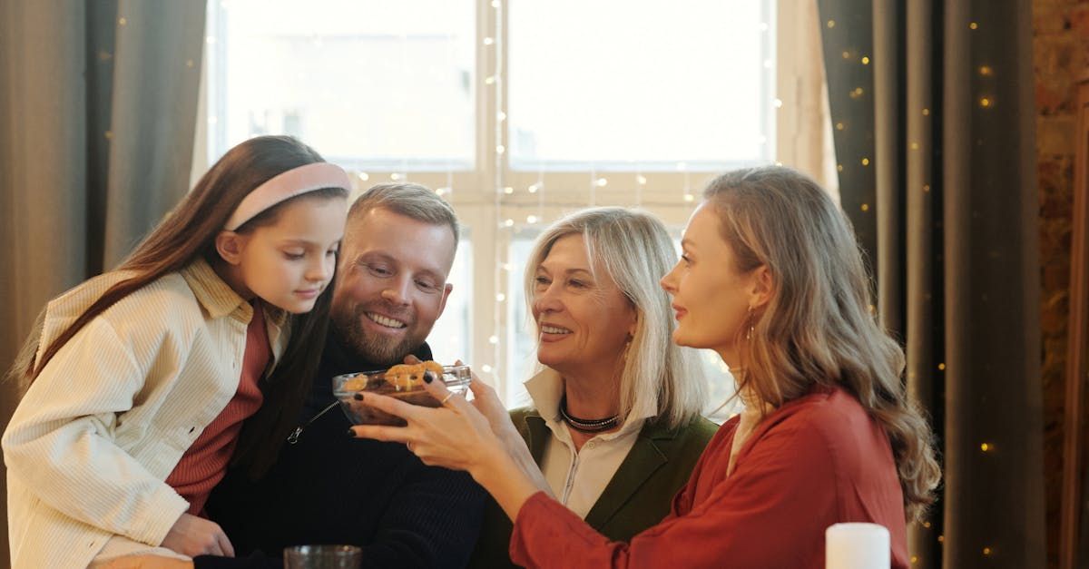 A family is sitting at a table eating food and drinking wine.