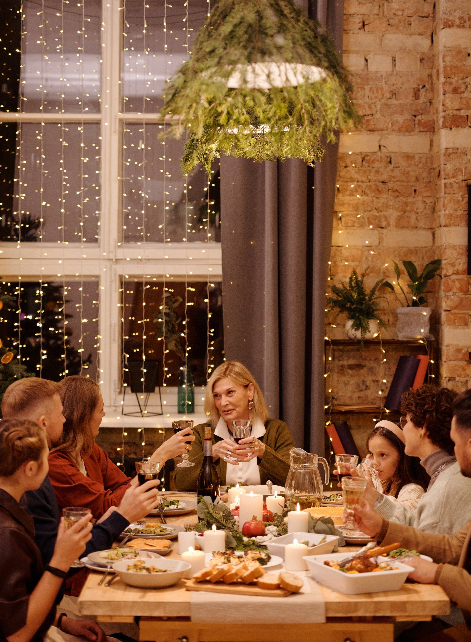 A group of people are sitting around a table eating christmas dinnerga
