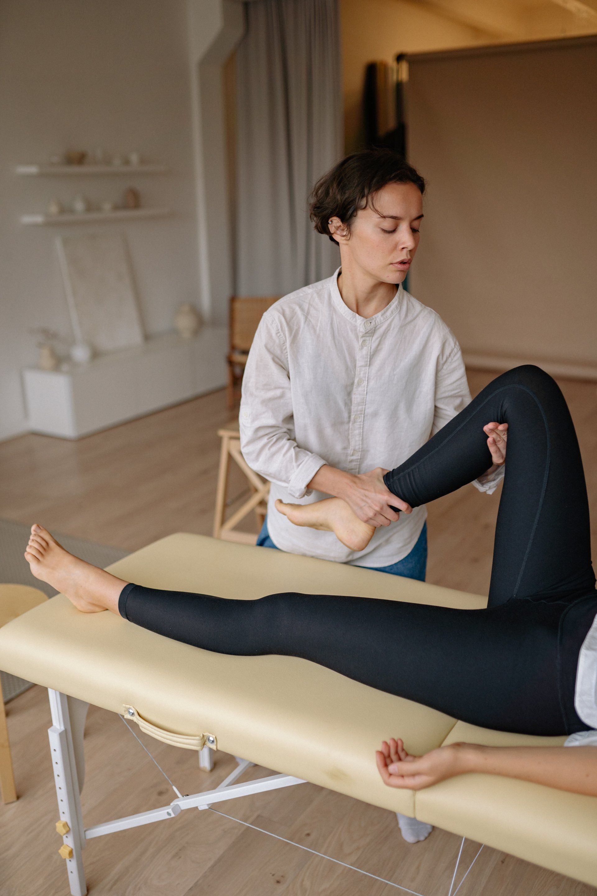 Woman receiving sports massage, focused on legs