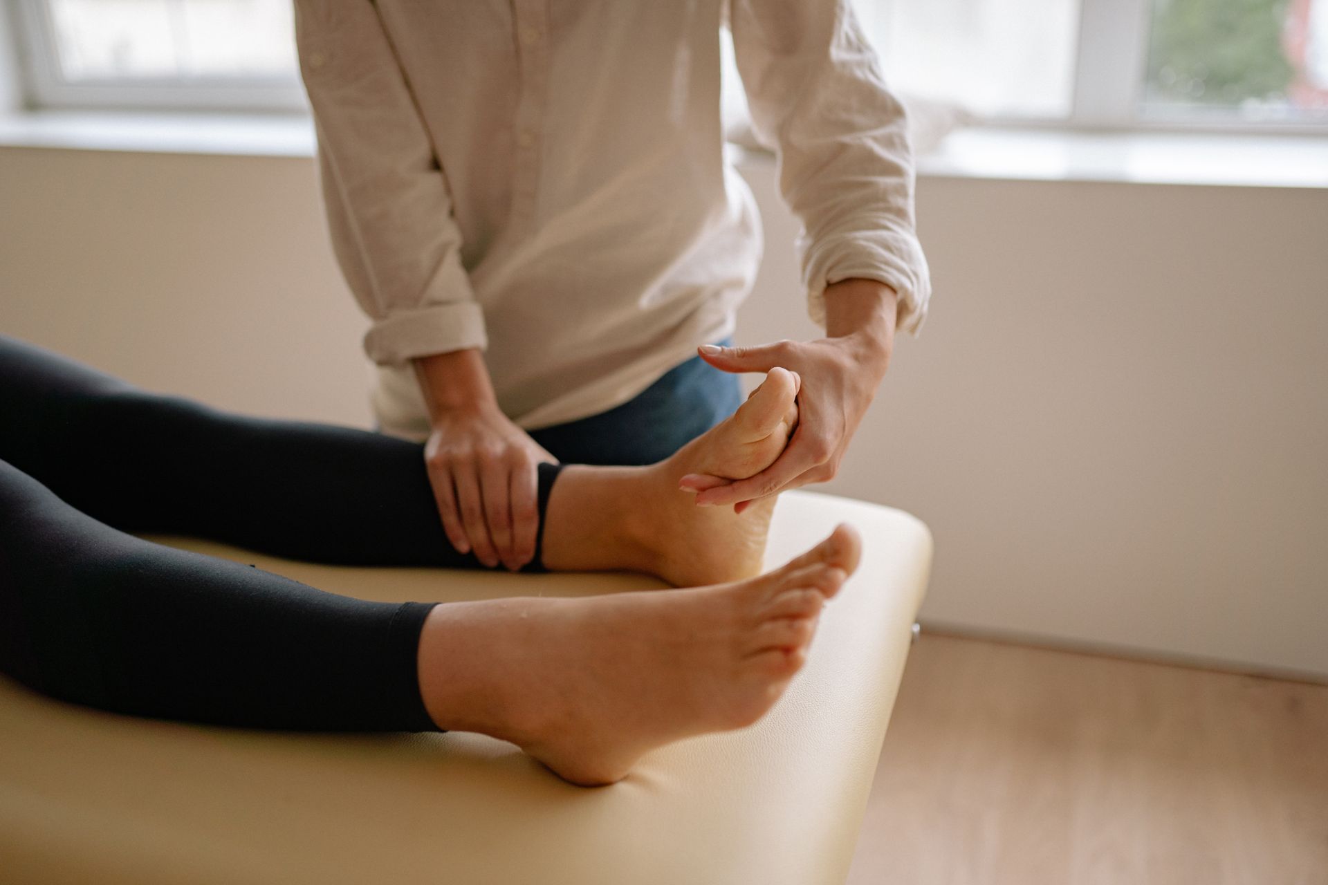 A person is giving a foot massage to another person.