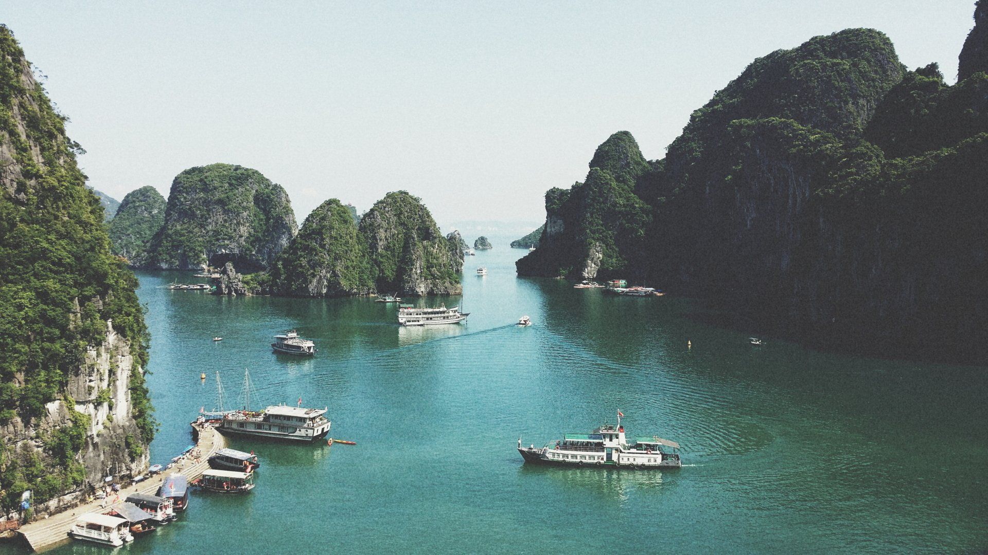 Emerald water with boats and limestone islands, Halong Bay, Vietnam.