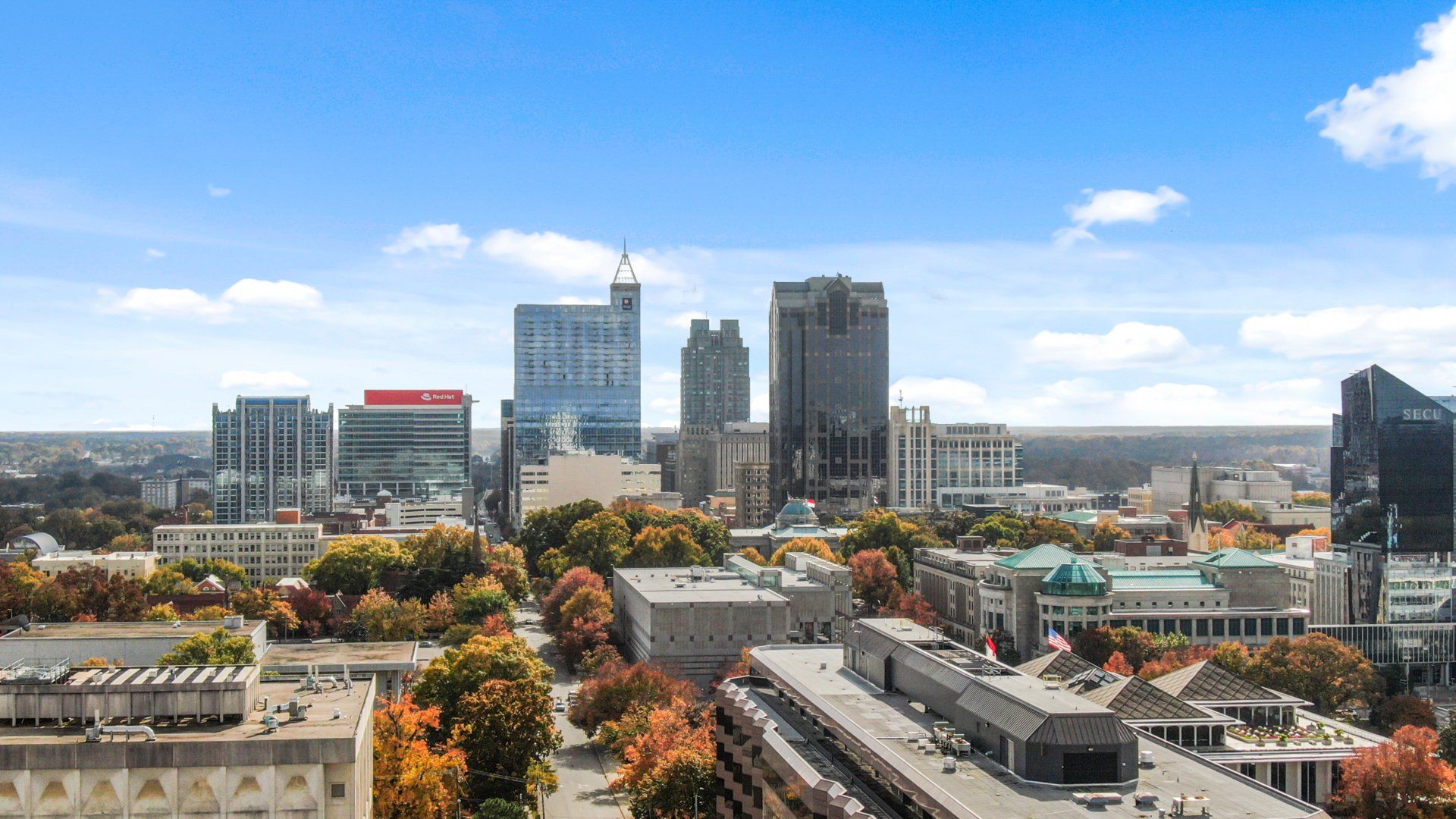 An aerial view of a city with lots of buildings and trees.