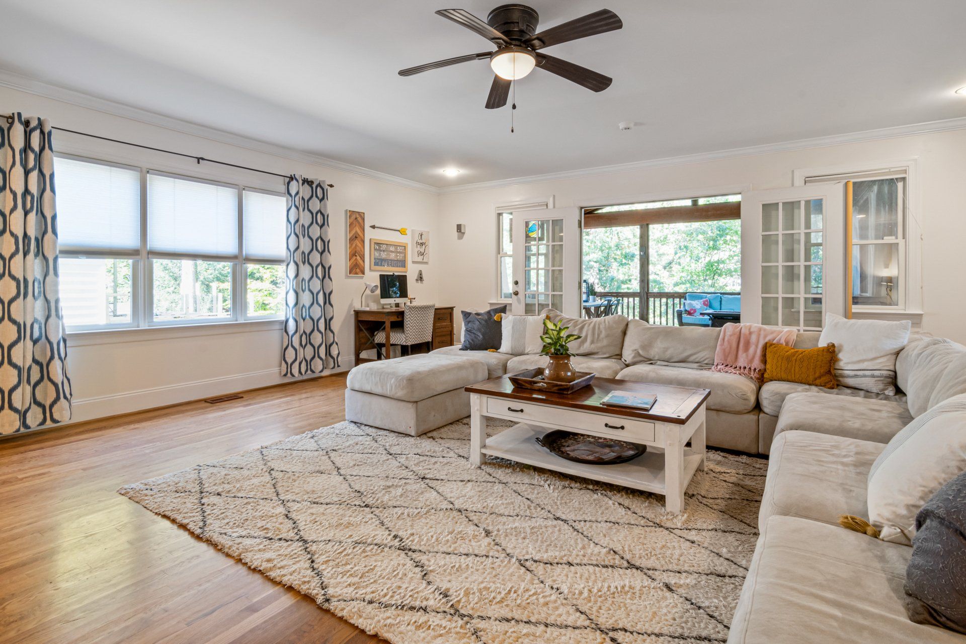A living room filled with furniture and a ceiling fan.