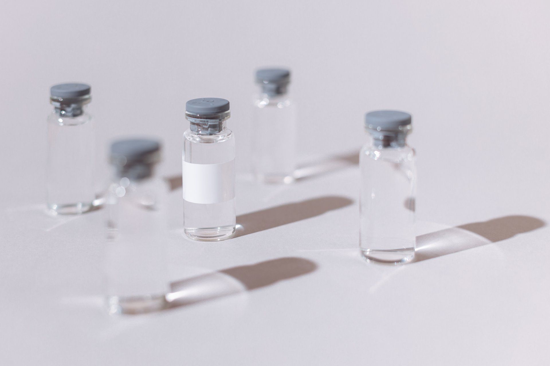 A group of small bottles filled with liquid are sitting on a table.