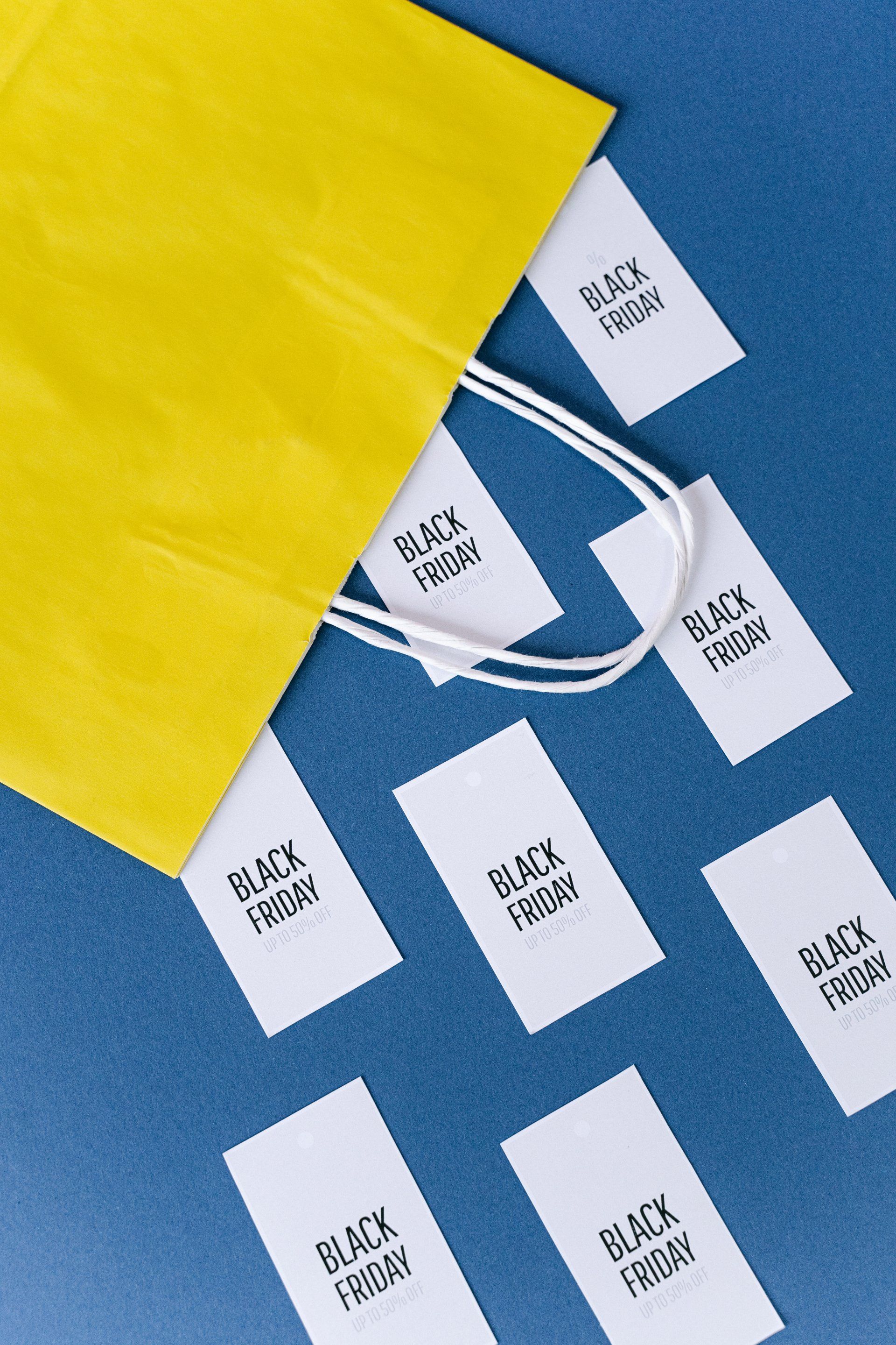 A yellow bag with black friday labels on it