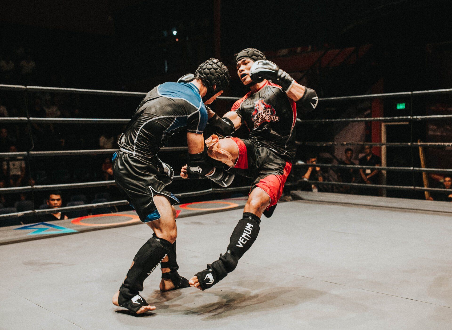 Two boxers are fighting in a boxing ring.