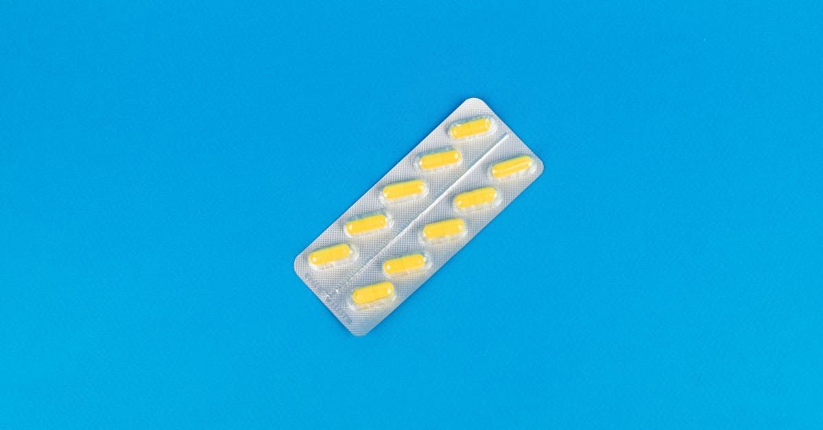 Blister pack of yellow pills on a blue background.