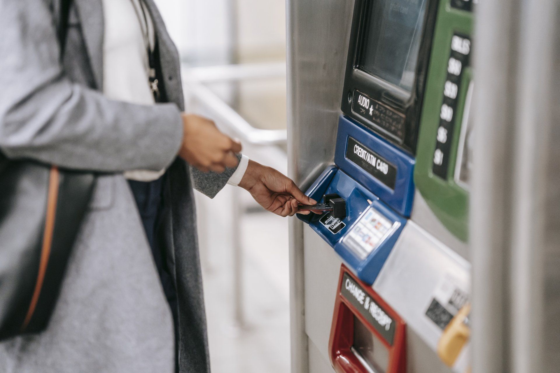 Girl in front of an ATM with a credit card